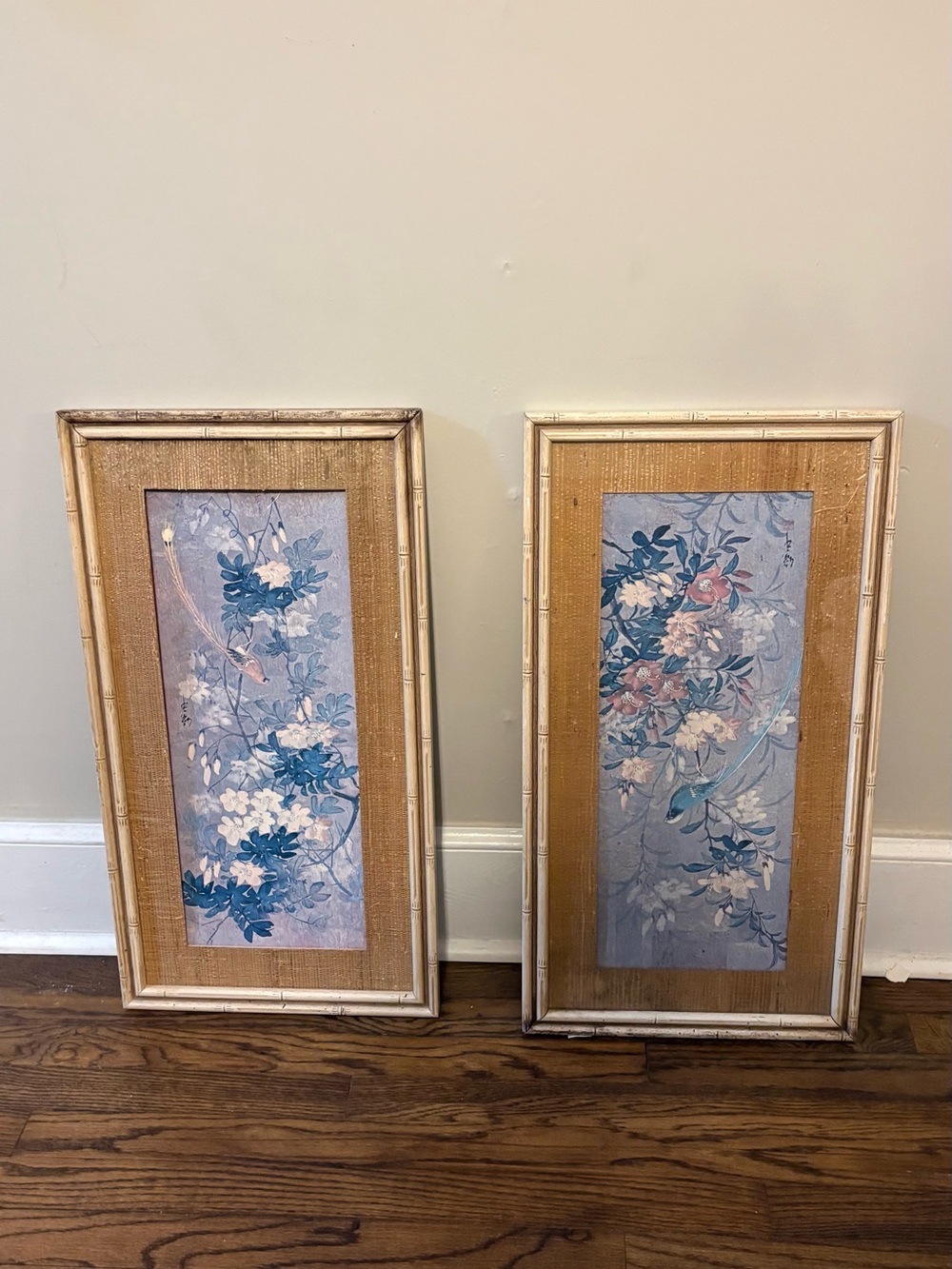 vintage Asian bird and flower paintings framed in faux bamboo.